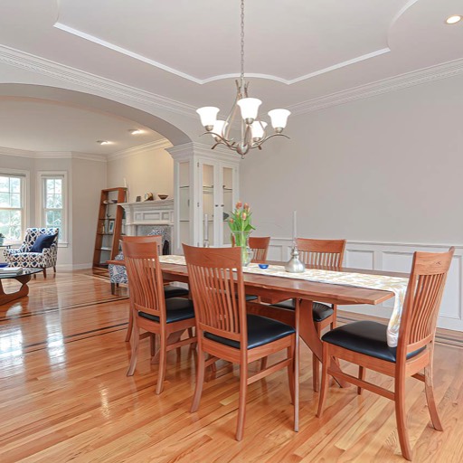 Dining room with raised tray ceiling and walnut inlay hardwood floors